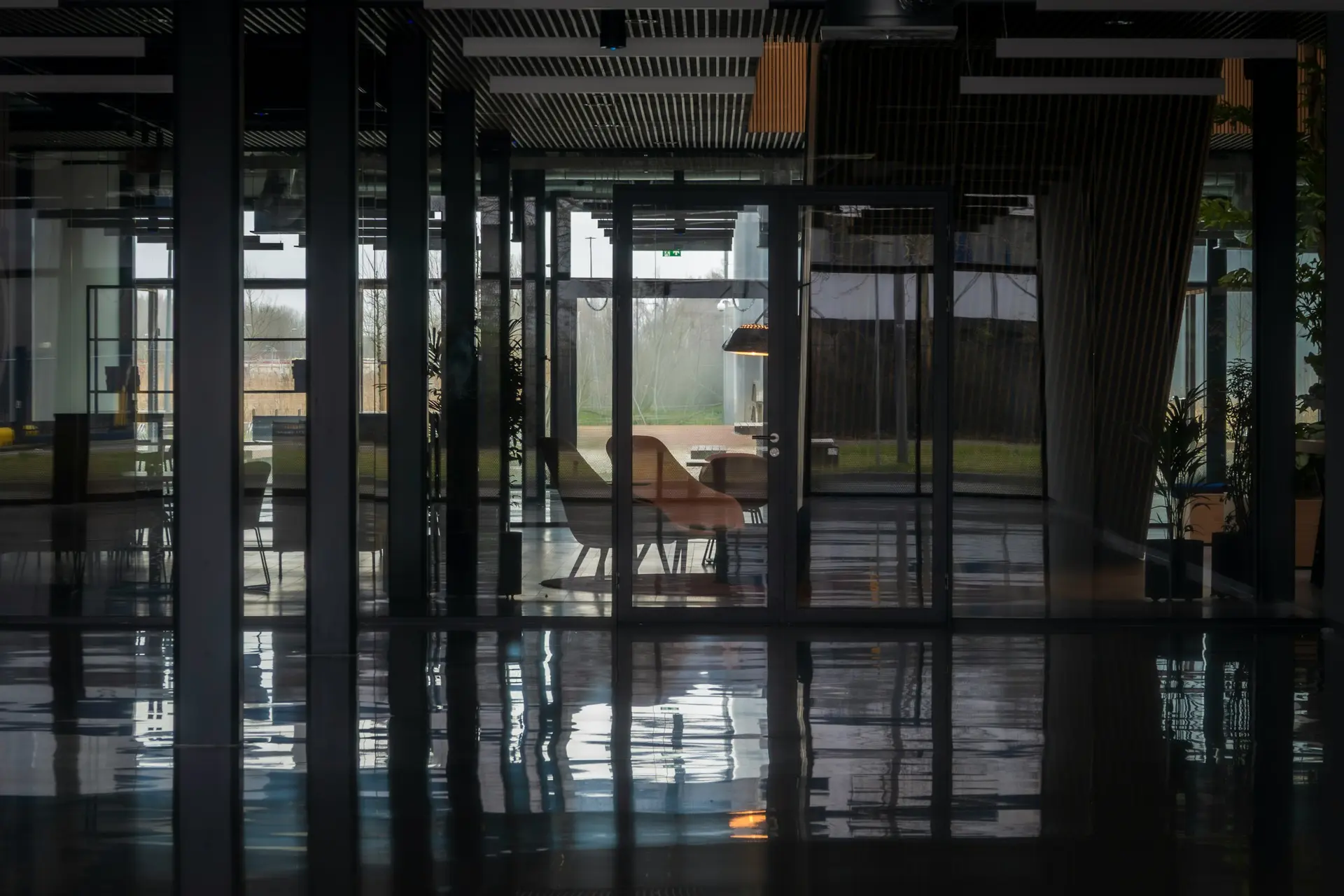 Empty commercial office interior before fit-out, with bare floors and daylight