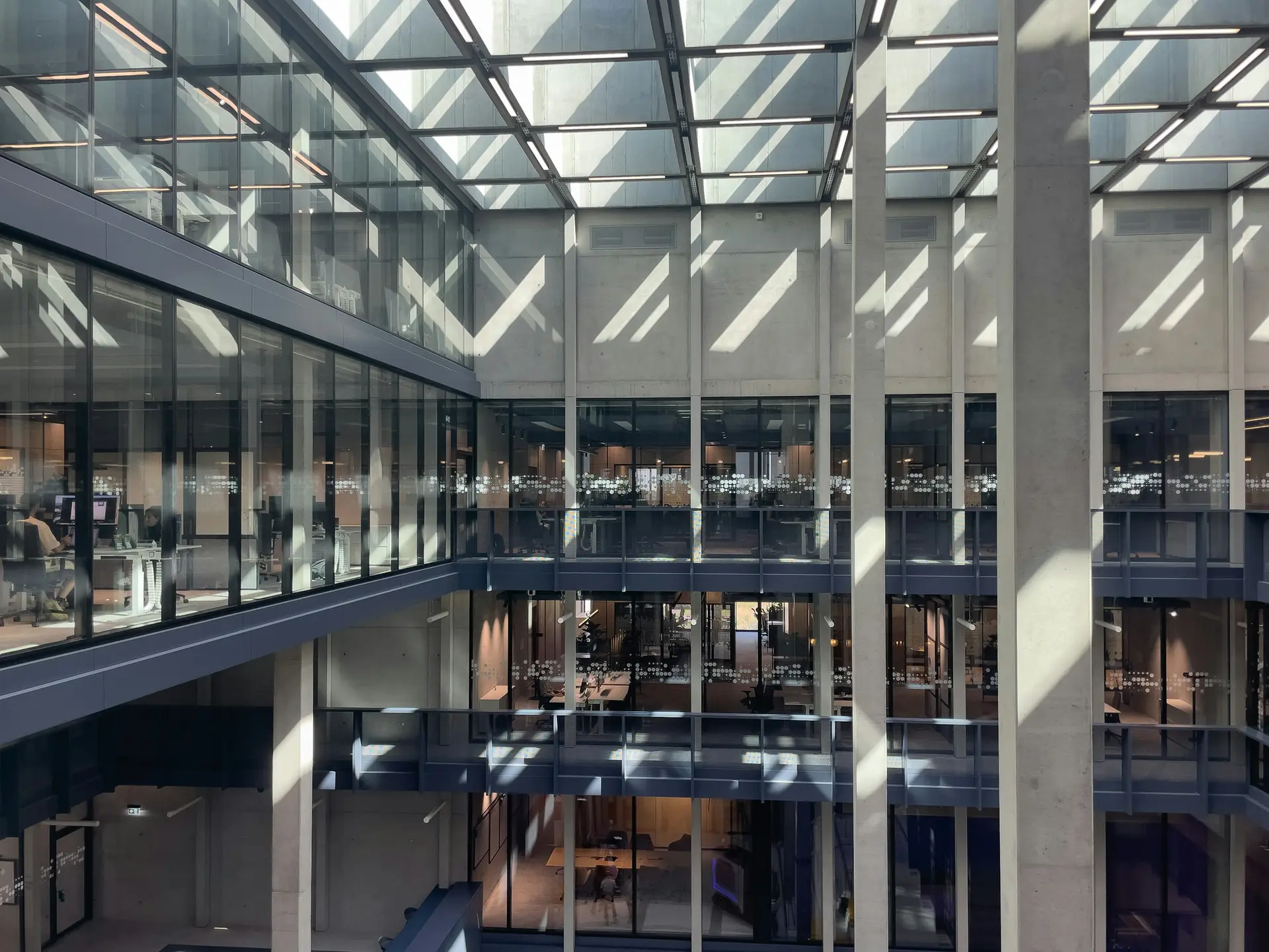 Open commercial workplace with a calm material palette and daylight